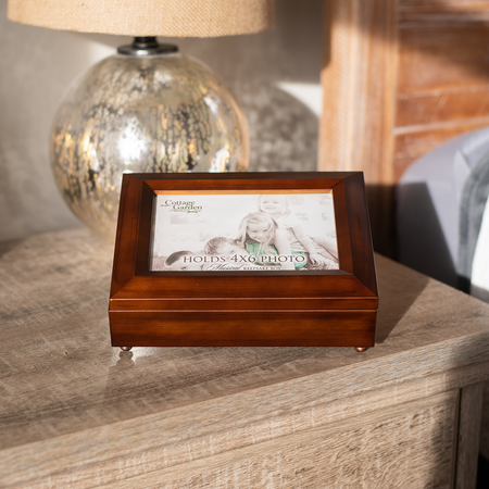 Modern wooden music box with replaceable image sitting on bedside table