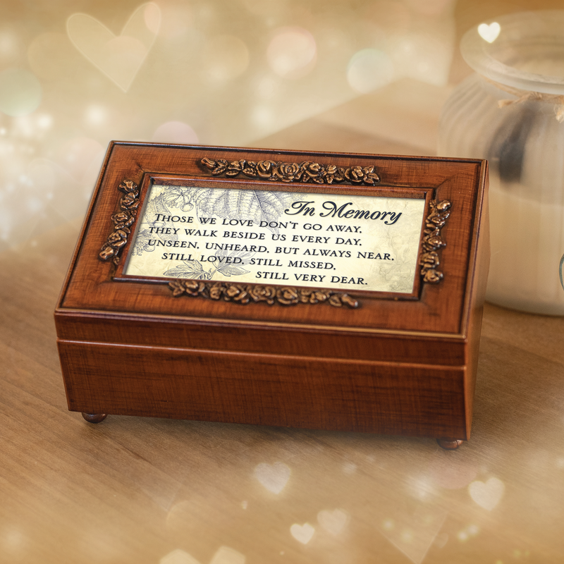 In memory bereavement music box with woodgrain rosette detail surrounded by heart bokeh